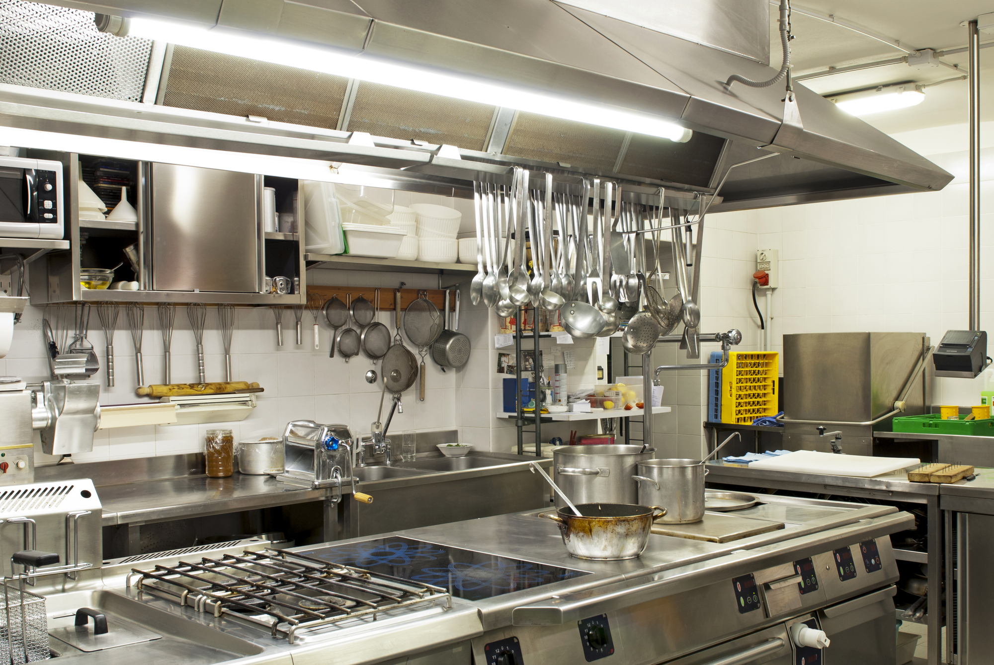 A catering kitchen featuring a stove and a sink